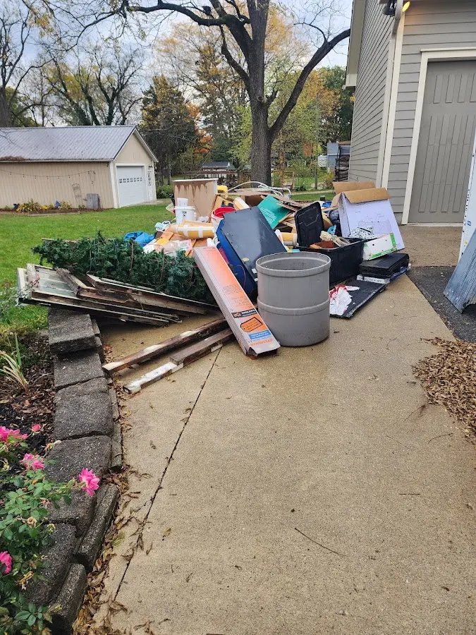 Dumpster being loaded with debris for 10 Yard Dumpster Rental in Stafford